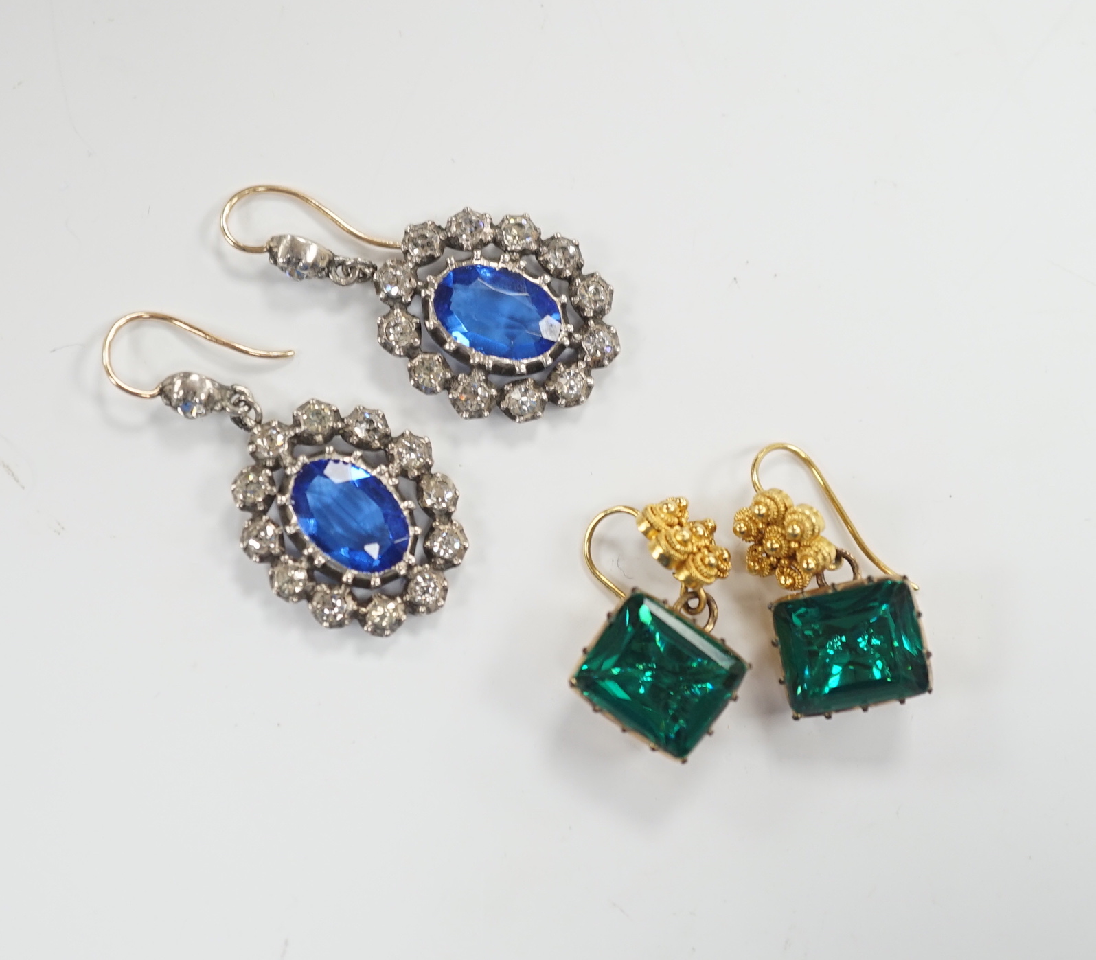 A pair of yellow metal and foil backed green paste set drop earrings, 11mm and a pair of blue and white paste set cluster drop earrings.